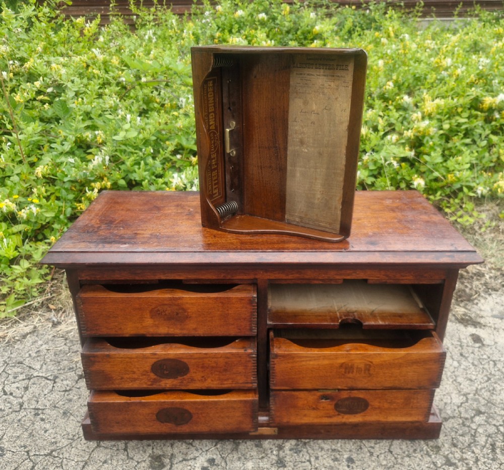 A 19th-century Victorian wooden tabletop Amberg filing cabinet with indexed drawers and an upper spring-loaded letter binder.