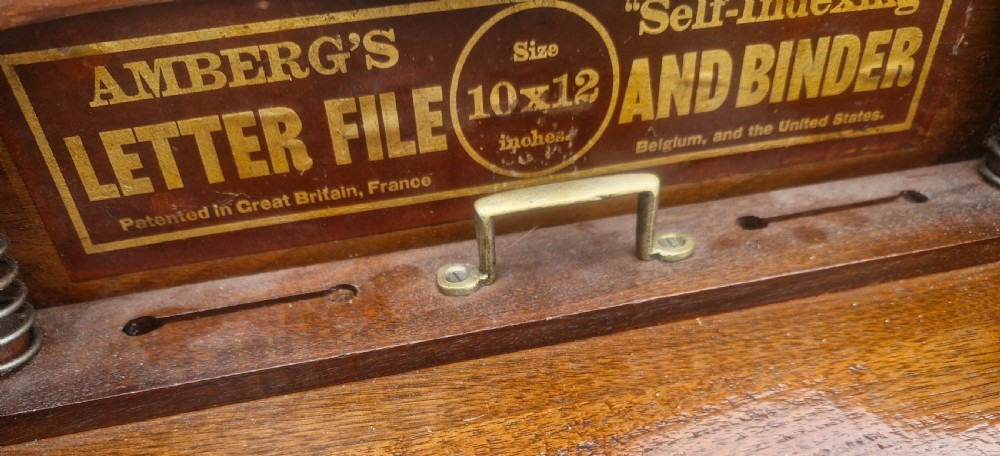 A 19th-century Victorian wooden tabletop Amberg filing cabinet with indexed drawers and an upper spring-loaded letter binder. View V