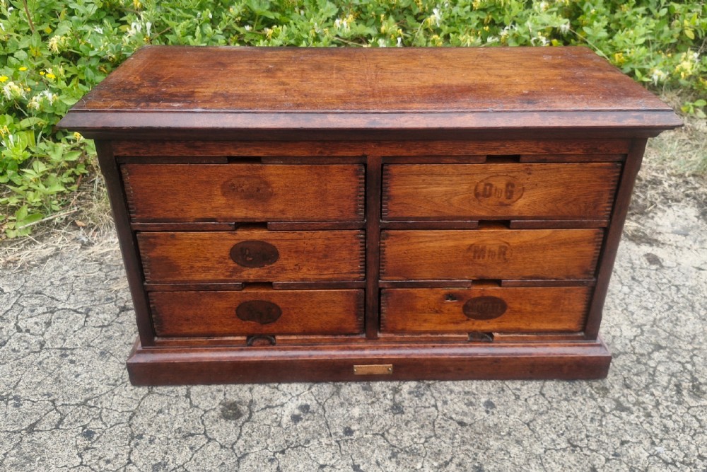 A 19th-century Victorian wooden tabletop Amberg filing cabinet with indexed drawers and an upper spring-loaded letter binder. View X