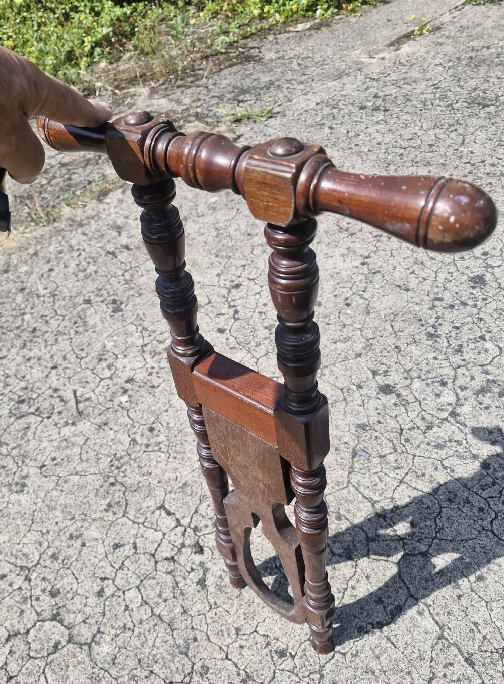 A late Victorian turned dark wood freestanding boot jack with twin upright handles and a horseshoe-shaped base for boot removal. View V