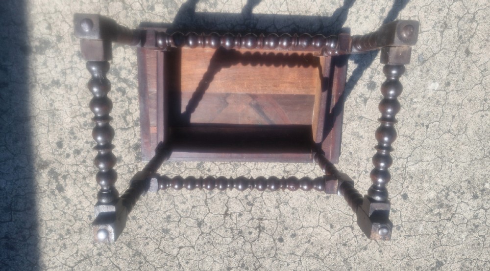 A mid-18th century dark oak side table featuring bobbin-turned legs and perimeter stretchers. View III