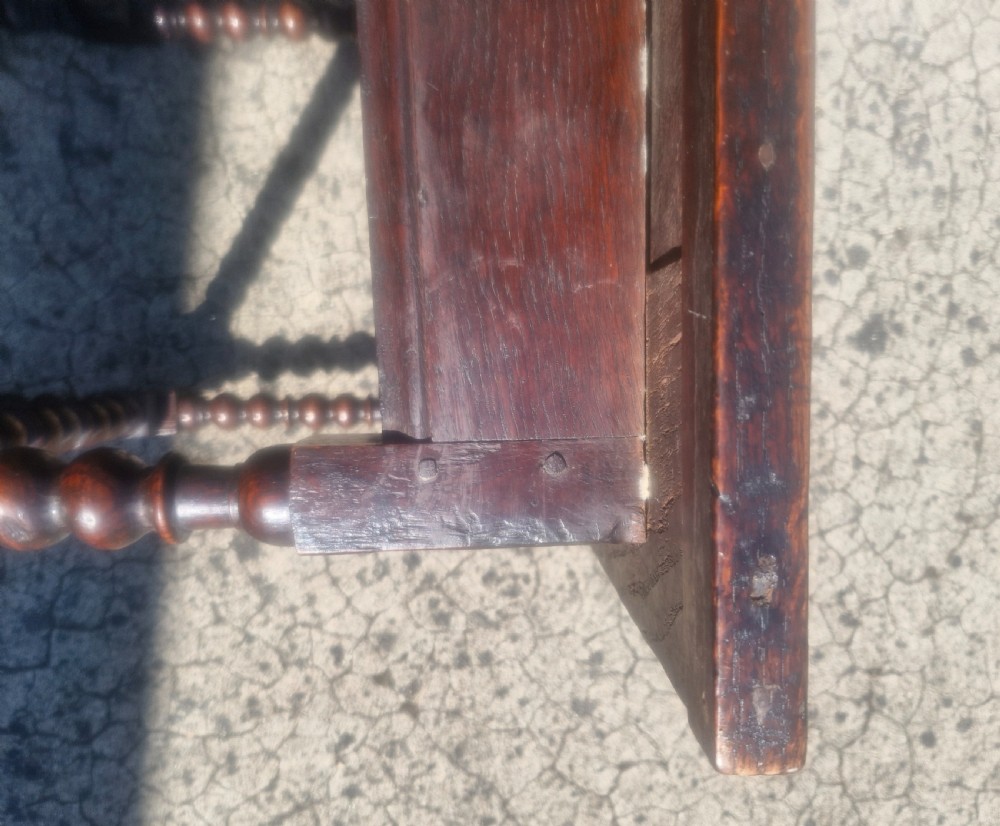 A mid-18th century dark oak side table featuring bobbin-turned legs and perimeter stretchers. View V