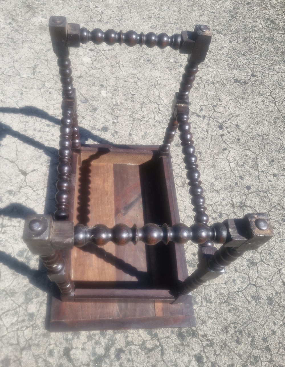 A mid-18th century dark oak side table featuring bobbin-turned legs and perimeter stretchers. View VI