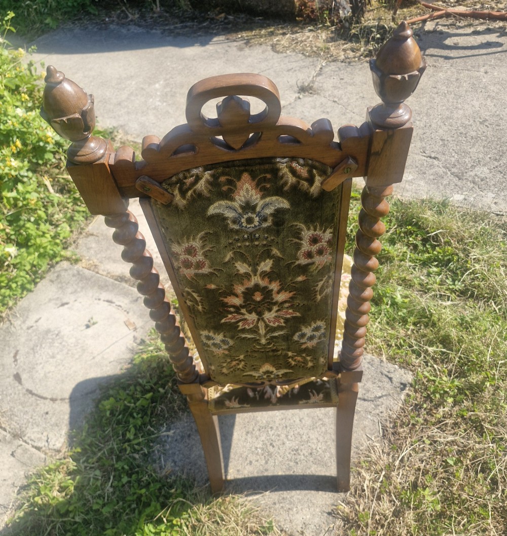A Mid-Victorian high back rosewood chair with spiral turned side posts, carved scroll cresting, and patterned olive green velvet upholstery. View VIII