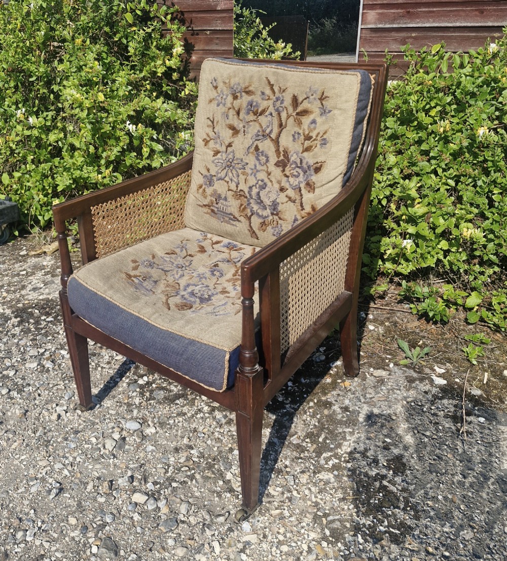 Mahogany bergere caned armchair with original cushions. 