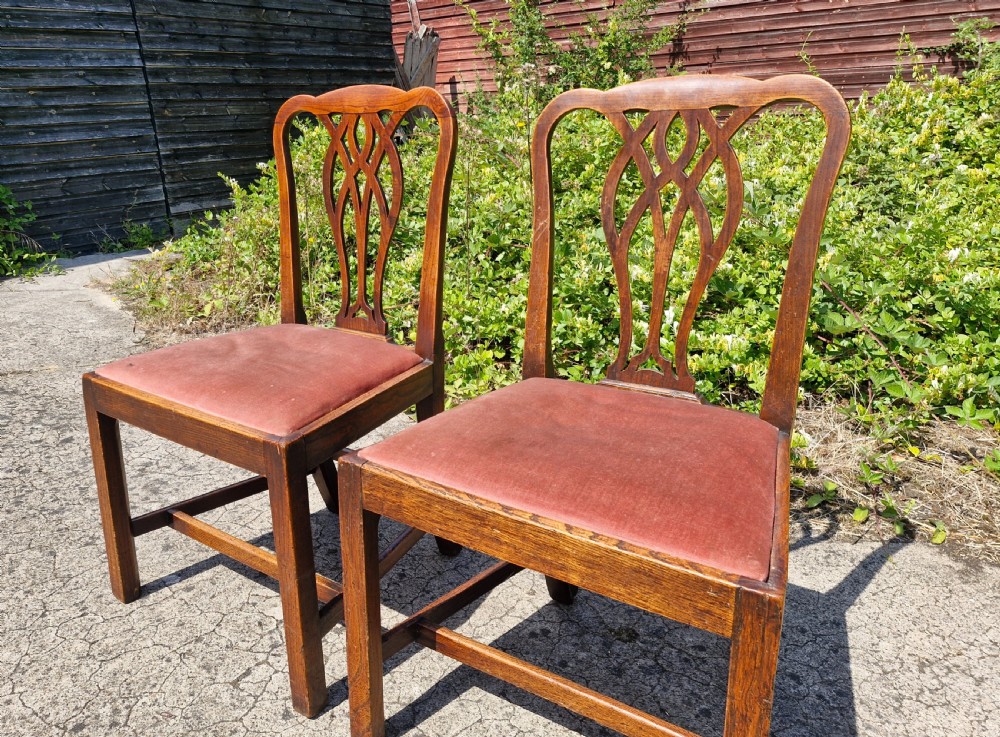 A pair of late Georgian elm side chairs featuring pierced interlaced back splats, square legs with stretchers, and terracotta upholstered drop-in seats. View II