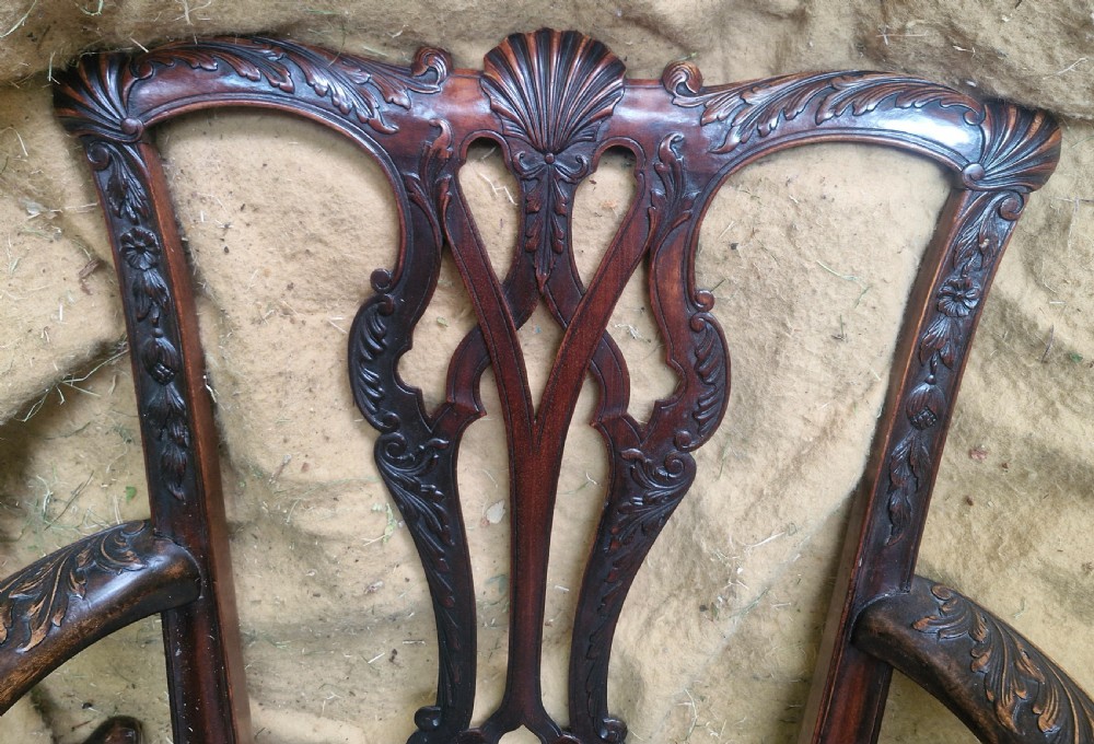 A set of eight dark mahogany Chippendale style dining chairs featuring carved splat backs, cabriole legs with ball and claw feet, and neutral patterned fabric seats. View II