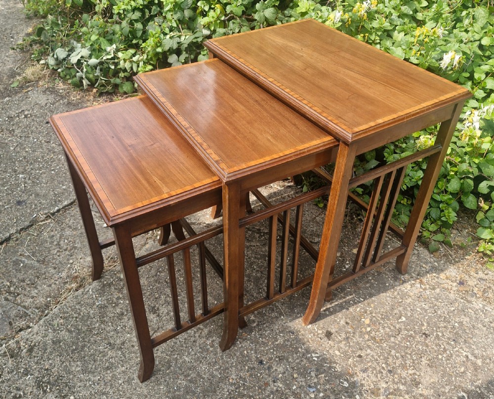 Nest of 3 Edwardian inlaid mahogany tables.