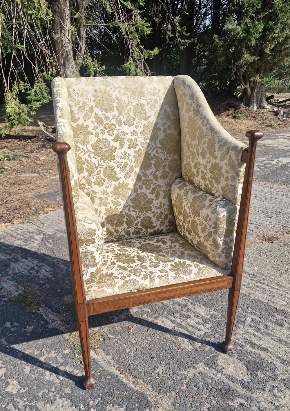 An Art Nouveau mahogany armchair featuring a high back, gold floral damask upholstery, boxwood inlay stringing, and extended vertical side supports ending in rounded finials. View IV