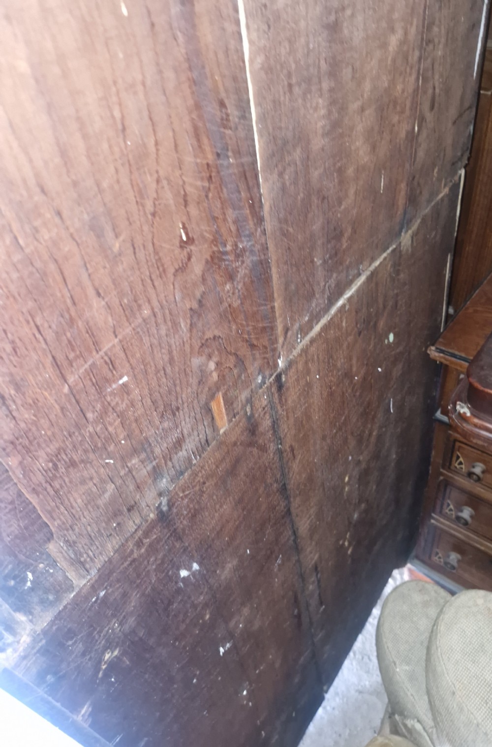 An antique two-part Welsh oak corner cupboard featuring upper astragal glazed doors with geometric panes and lower panelled cupboard doors. View IV