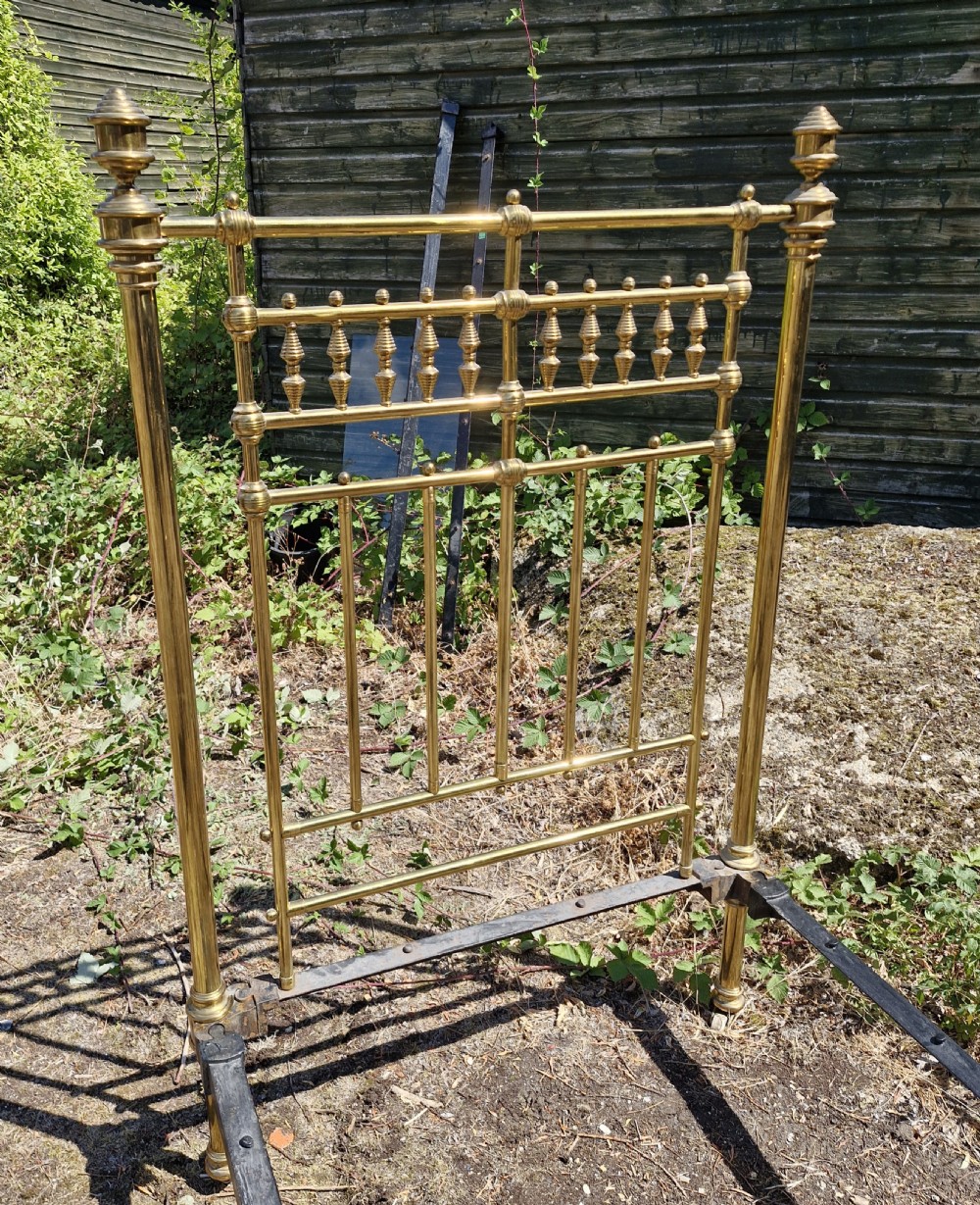 Victorian brass single bedstead featuring turned finials, spindled headboard and footboard, and iron side rails. View IV