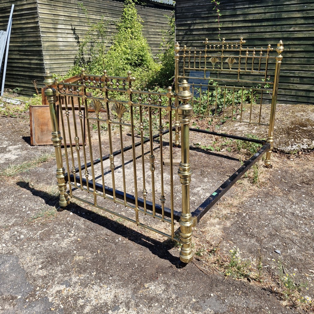 A Victorian double brass bed frame featuring turned posts, decorative finials, vertical metal spindles, and cast iron side rails. View III