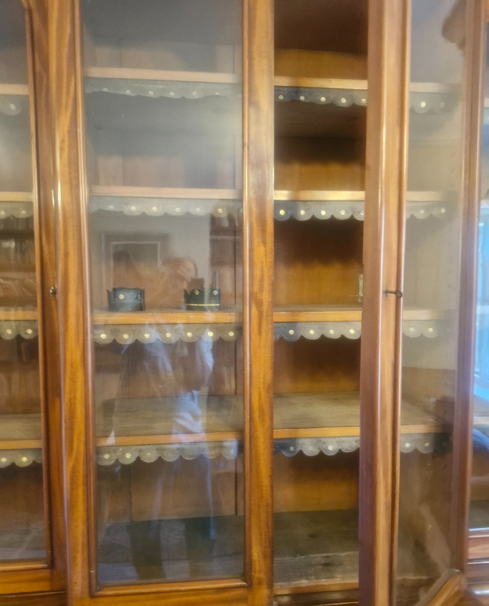 A large Victorian mahogany breakfront library bookcase featuring four glazed upper doors and panelled lower cupboard doors on a plinth base. View II