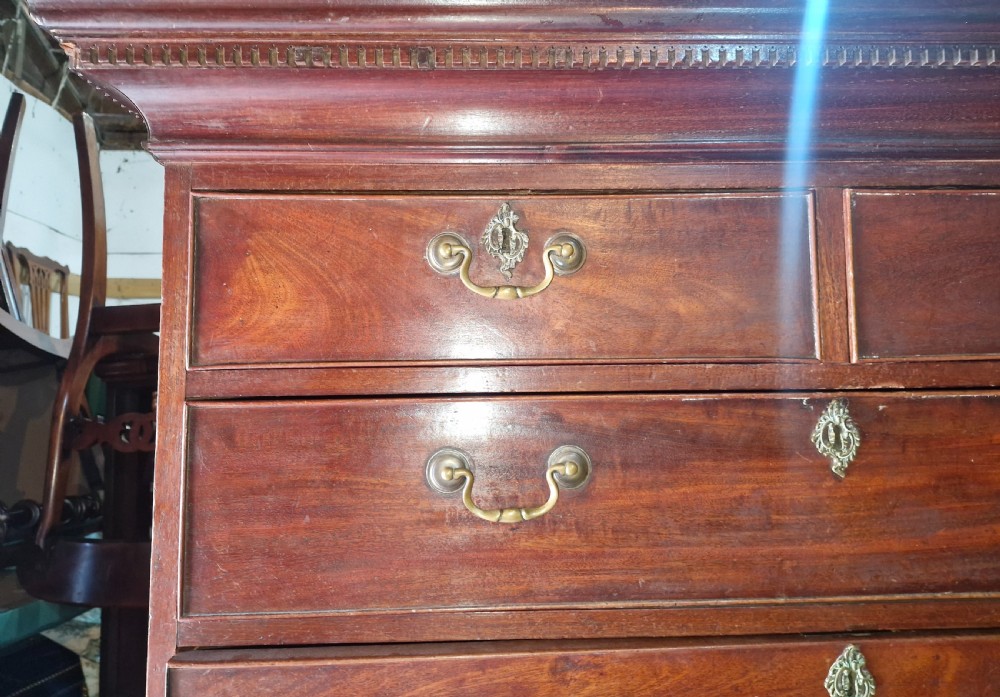 A late Georgian tall mahogany chest on chest featuring two short drawers over six long drawers with brass handles and a dentil cornice. View IV