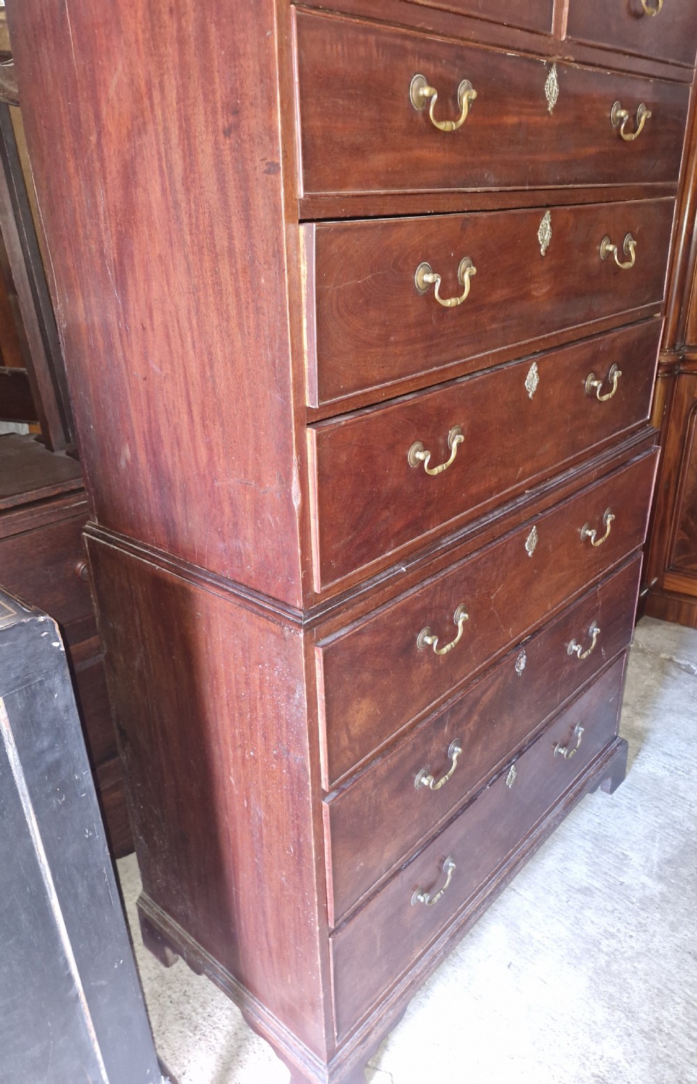 A late Georgian tall mahogany chest on chest featuring two short drawers over six long drawers with brass handles and a dentil cornice. View V