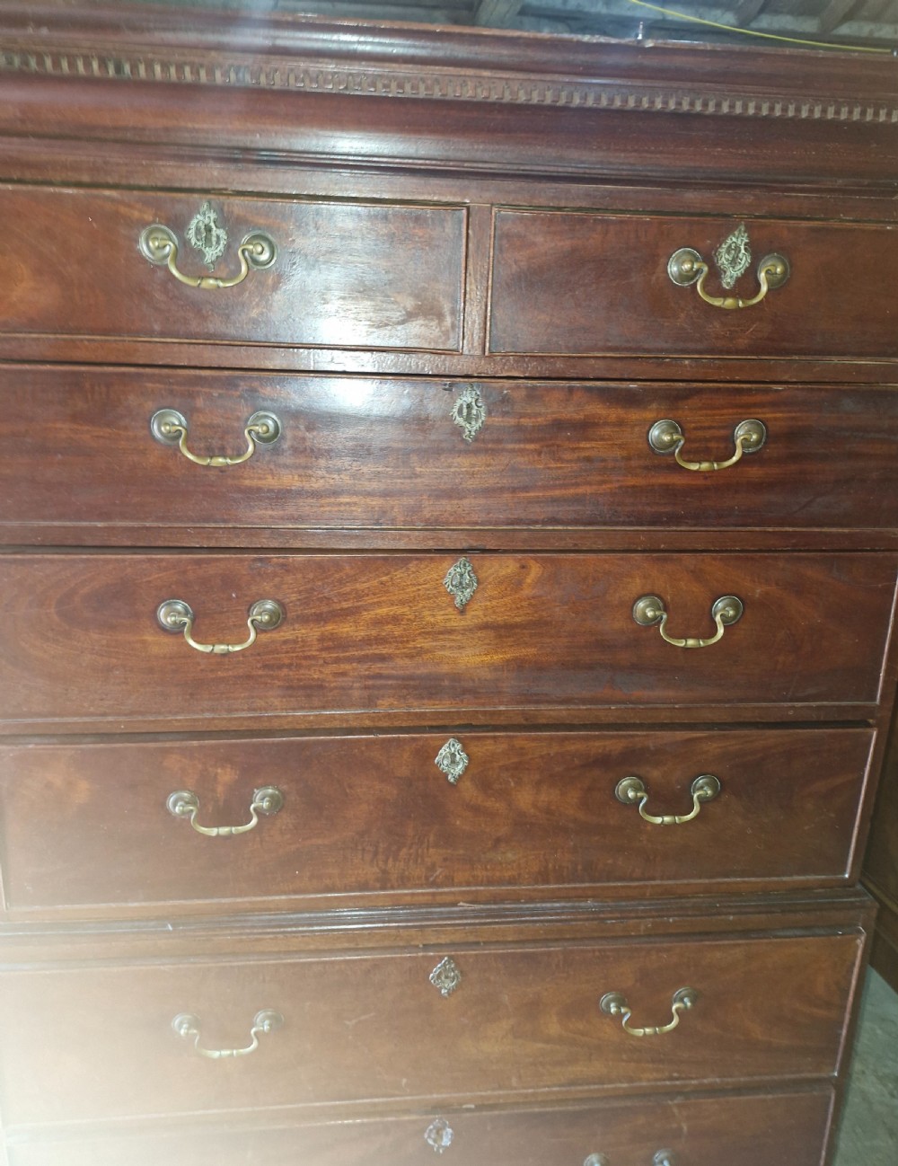 A late Georgian tall mahogany chest on chest featuring two short drawers over six long drawers with brass handles and a dentil cornice. View VII