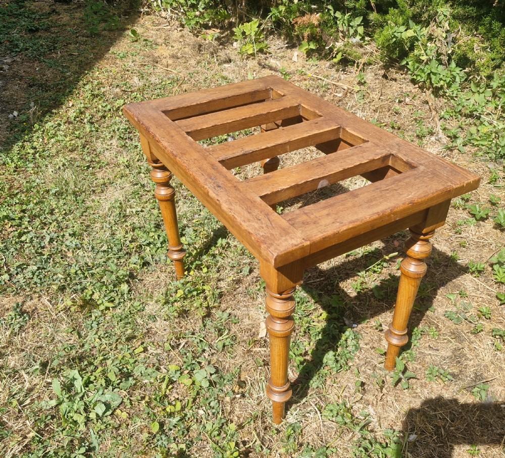 An Edwardian ash luggage stand with a rectangular slatted timber top and four turned wooden legs. View IV