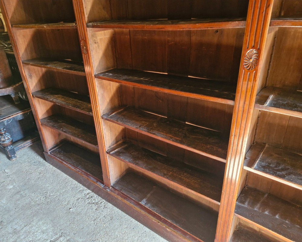 A large, three-section antique mahogany open-front bookcase with adjustable shelves and fluted pilasters. View VII