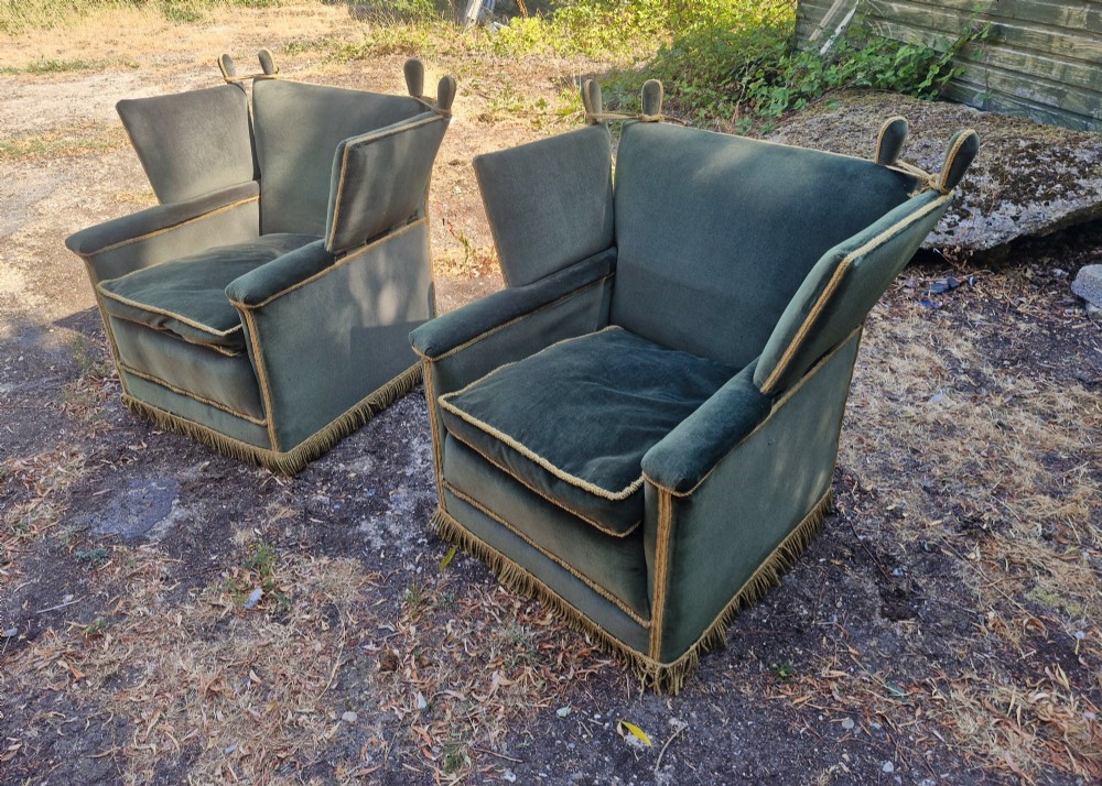 A pair of olive green velvet Knole armchairs featuring drop-side arms with finial ties, gold piping, and lower fringe trim. View III