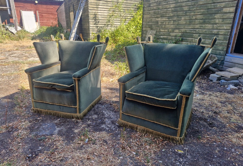 A pair of olive green velvet Knole armchairs featuring drop-side arms with finial ties, gold piping, and lower fringe trim. View IV