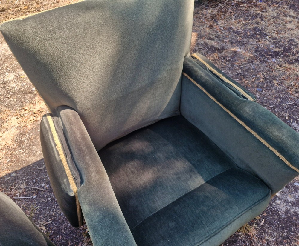 A pair of olive green velvet Knole armchairs featuring drop-side arms with finial ties, gold piping, and lower fringe trim. View VI