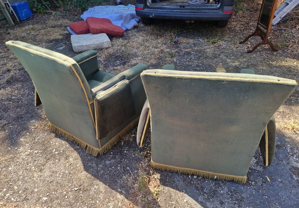 A pair of olive green velvet Knole armchairs featuring drop-side arms with finial ties, gold piping, and lower fringe trim. View VIII