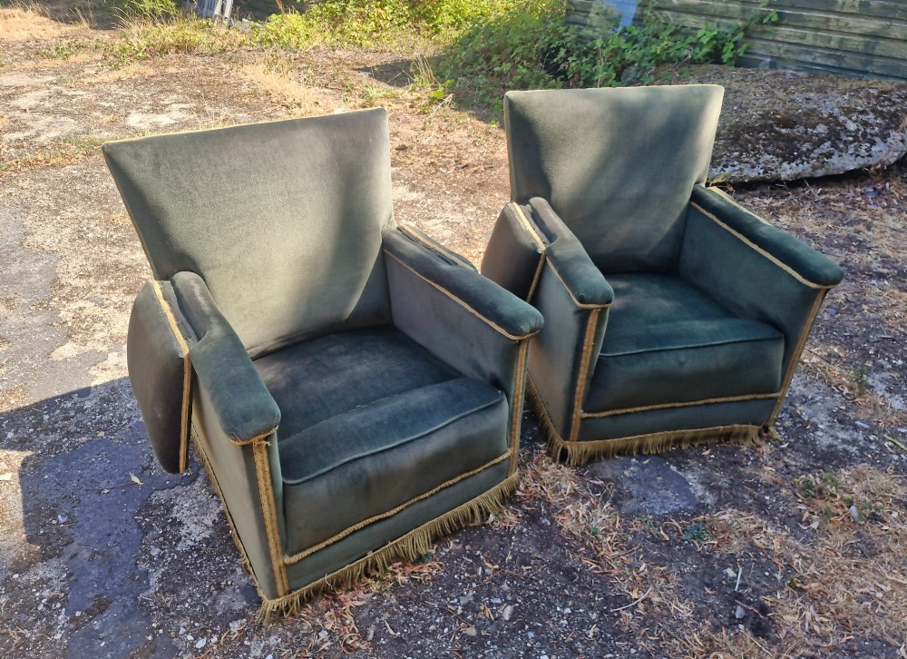A pair of olive green velvet Knole armchairs featuring drop-side arms with finial ties, gold piping, and lower fringe trim. View IX