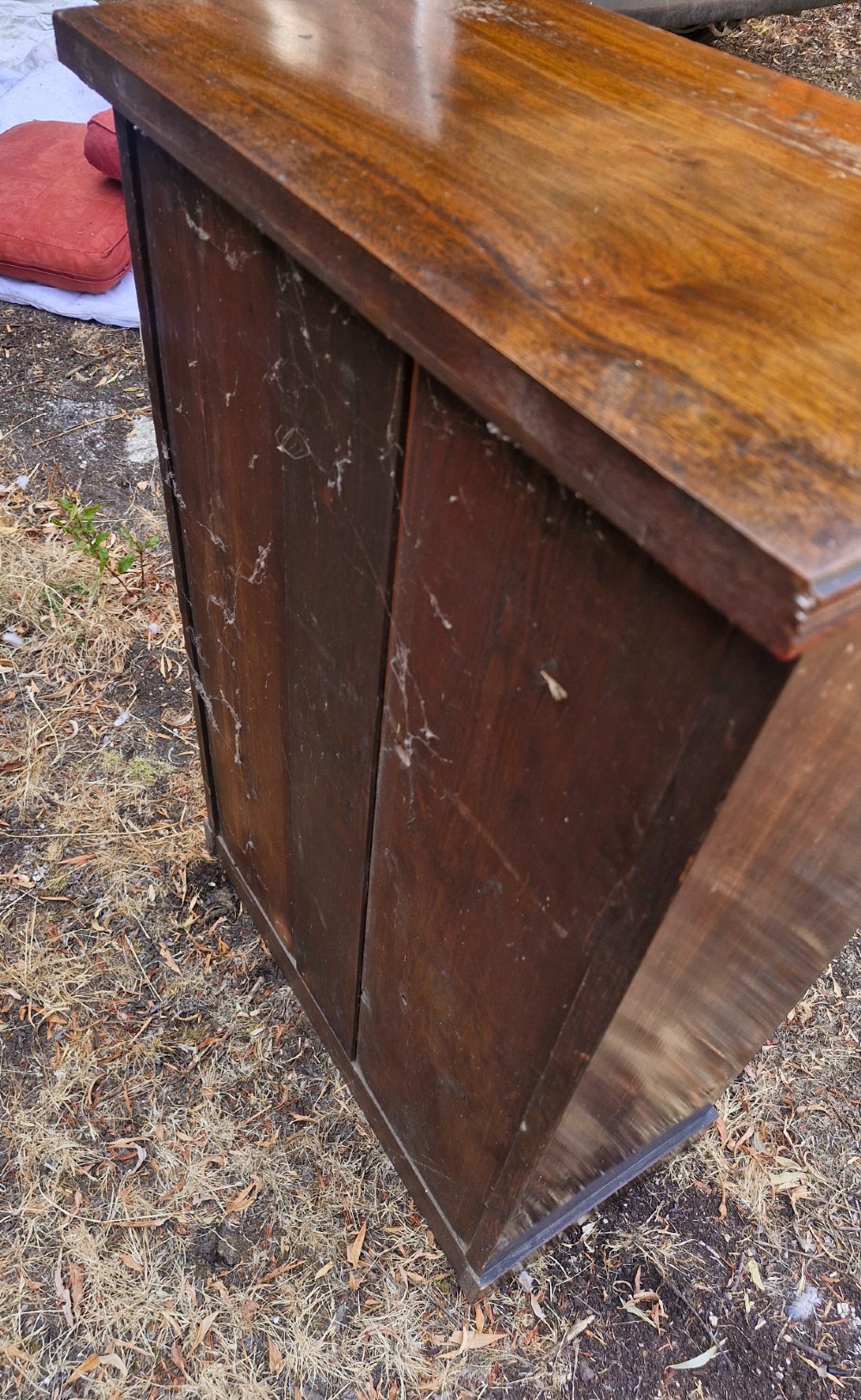 A small late Victorian dark walnut open bookcase with carved corner corbels, three shelf compartments, and a solid plinth base. View II
