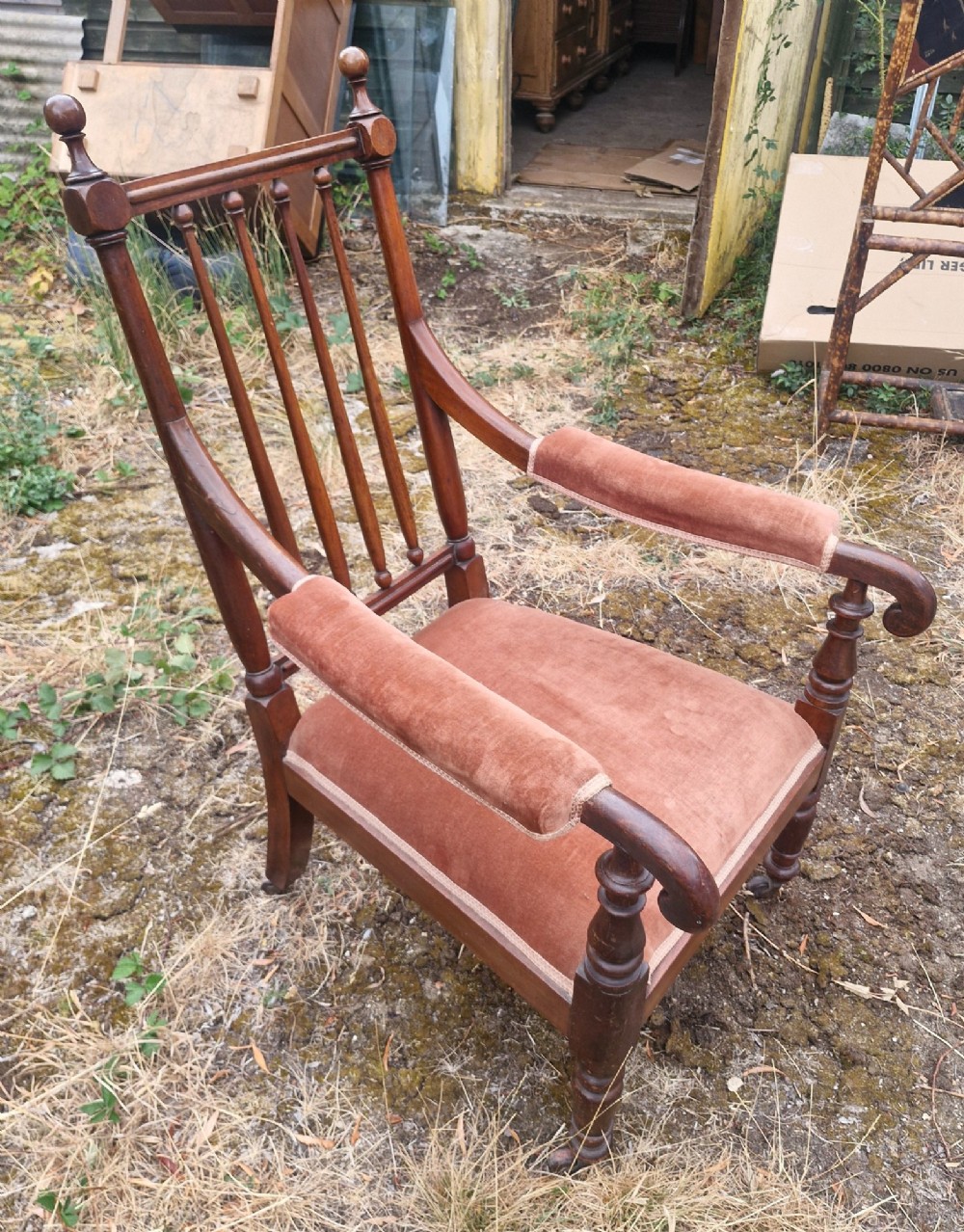 An early Victorian mahogany armchair featuring a spindle backrest, padded velvet armrests, a cushioned brown velvet seat, and turned wooden front legs. View III
