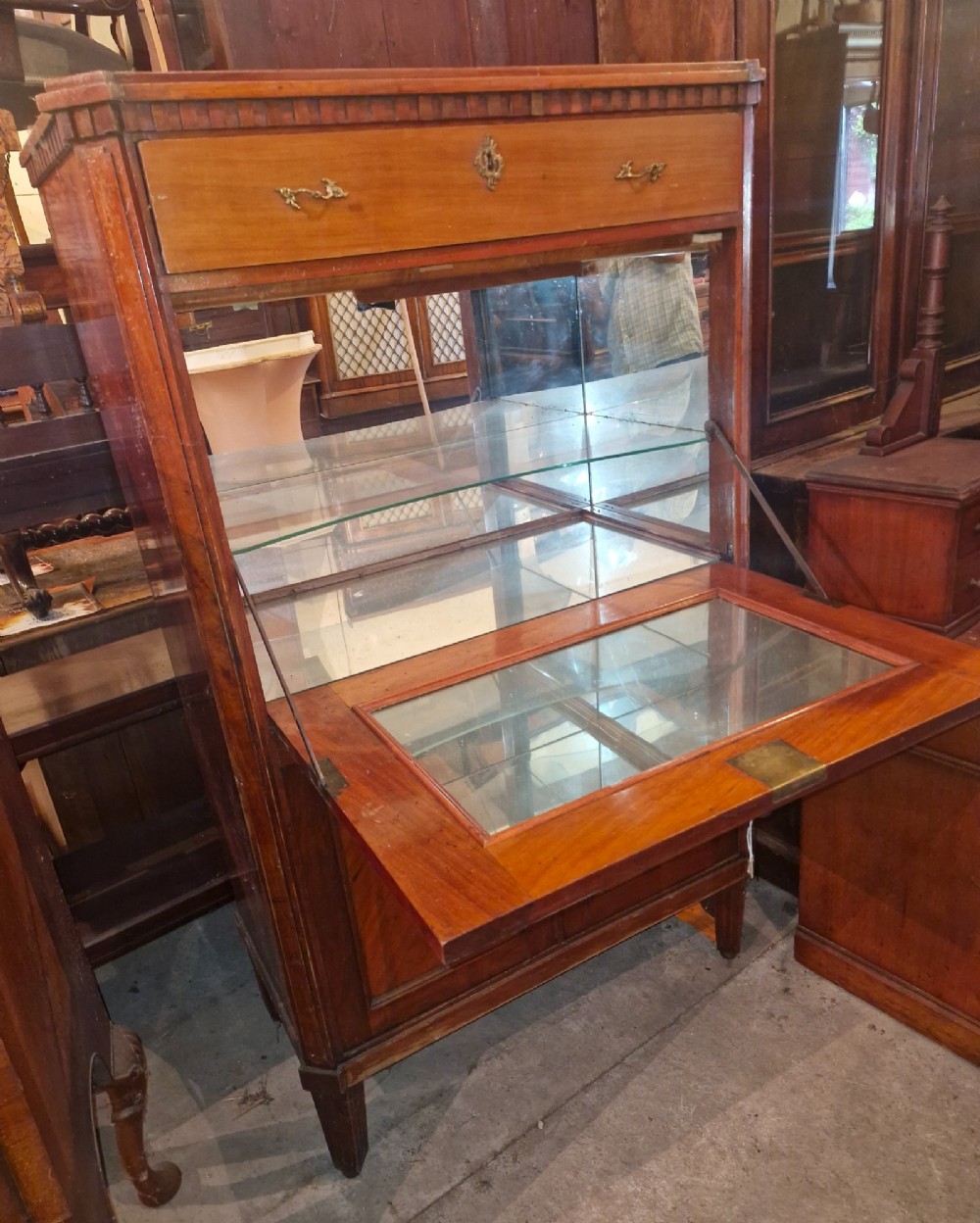 Antique mahogany secretaire cocktail cabinet featuring chevron wood veneer inlays, brass corner mounts, drop-front panel, upper drawer, and lower double doors. View III