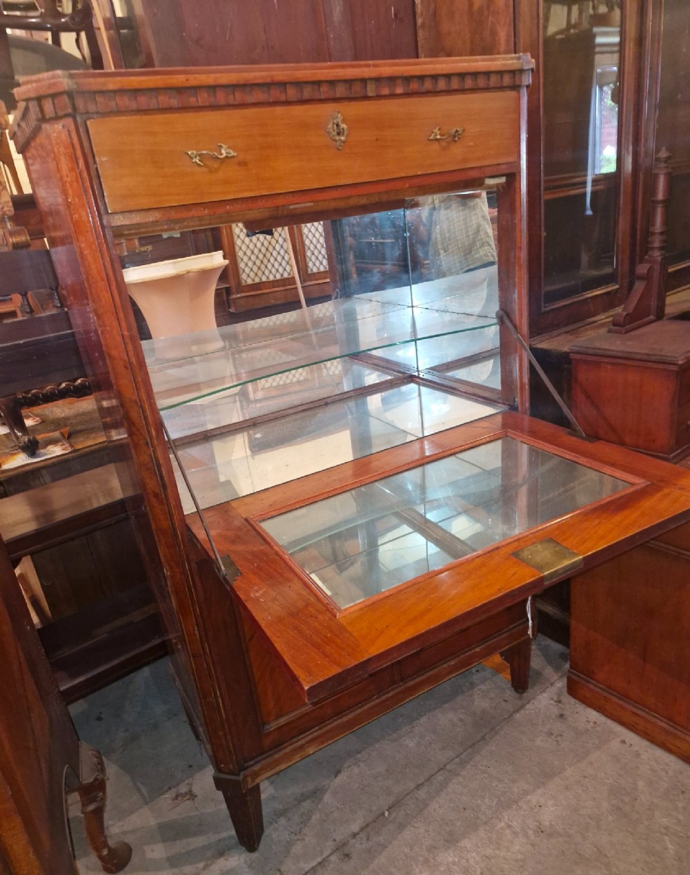 Antique mahogany secretaire cocktail cabinet featuring chevron wood veneer inlays, brass corner mounts, drop-front panel, upper drawer, and lower double doors. View IV