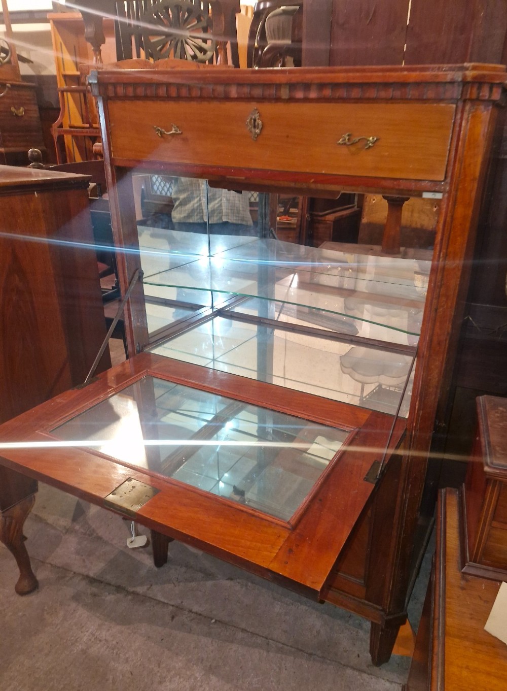 Antique mahogany secretaire cocktail cabinet featuring chevron wood veneer inlays, brass corner mounts, drop-front panel, upper drawer, and lower double doors. View V