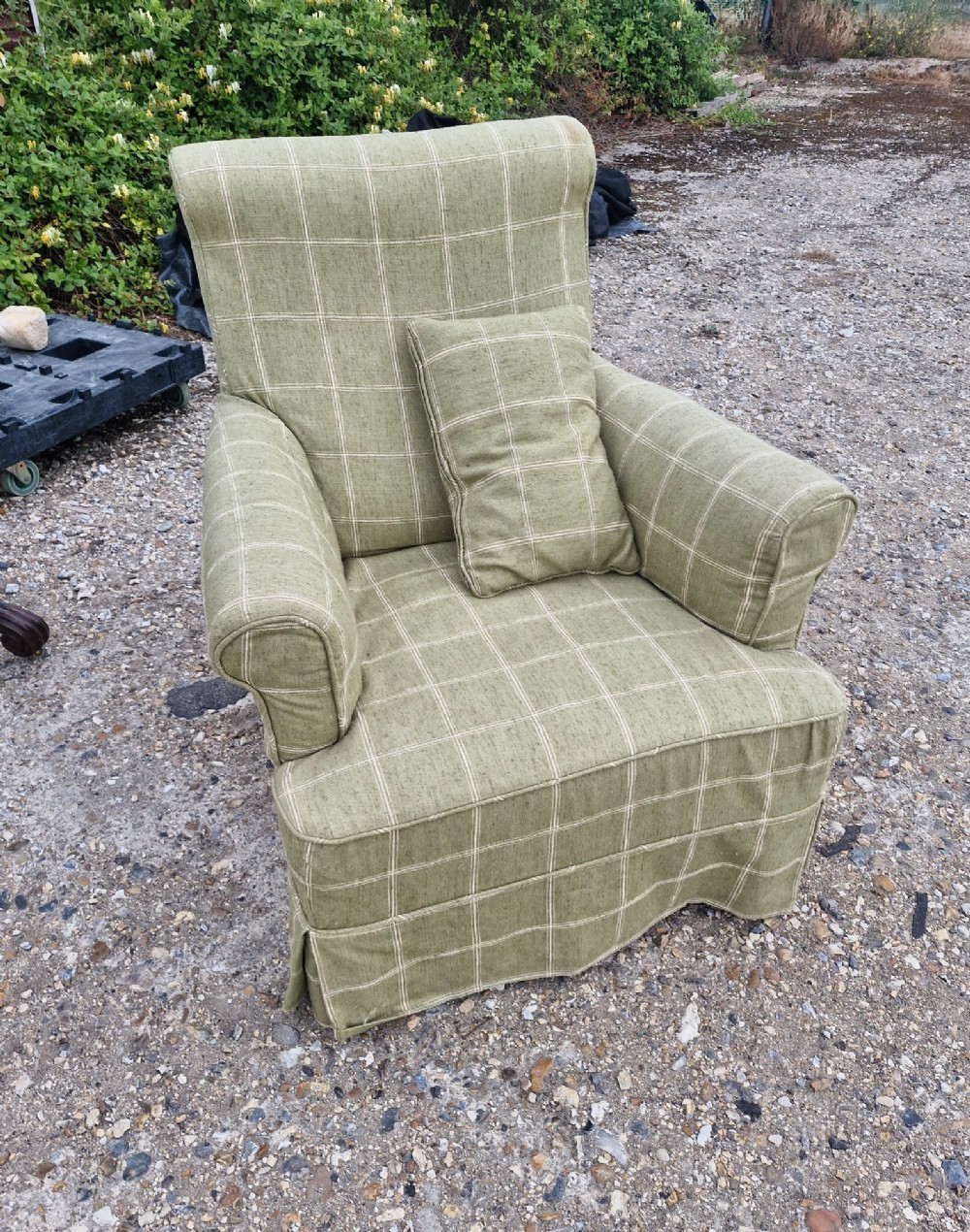 A late Victorian upholstered armchair in neutral cream fabric featuring a scrolled backrest, padded armrests, and turned mahogany front legs on brass castors. View III