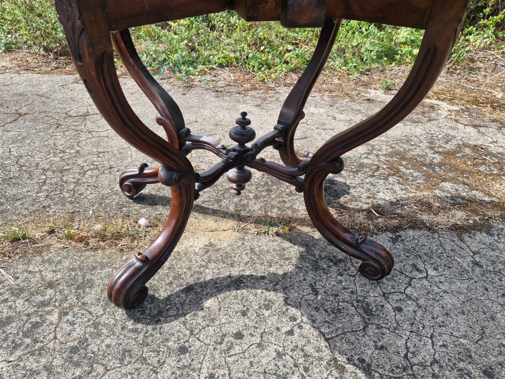A Victorian burr walnut scissor action table featuring a shaped oval top with distinct figure grain and carved cabriole legs with a central turned stretcher finial. View XII