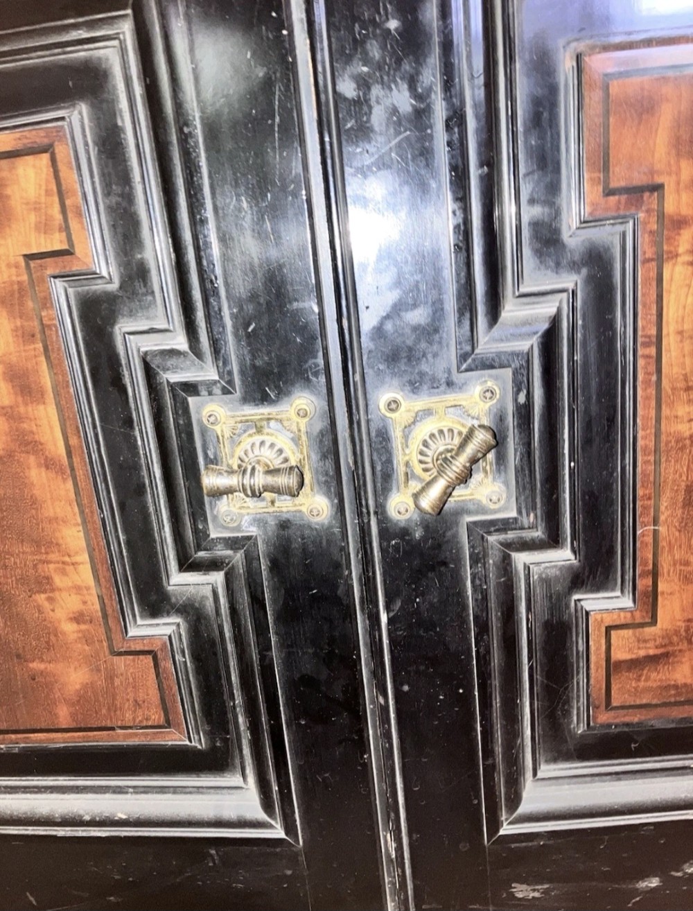 A large Victorian ebonised and mahogany breakfront library bookcase featuring glazed upper doors, panelled lower cupboards, and fluted side pilasters. View V