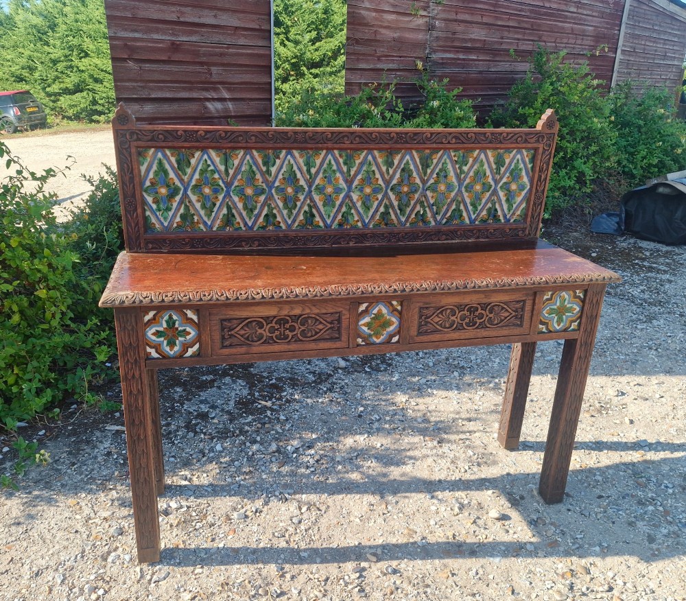 Late Victorian oak 2 drawer side table with decorative tiles.