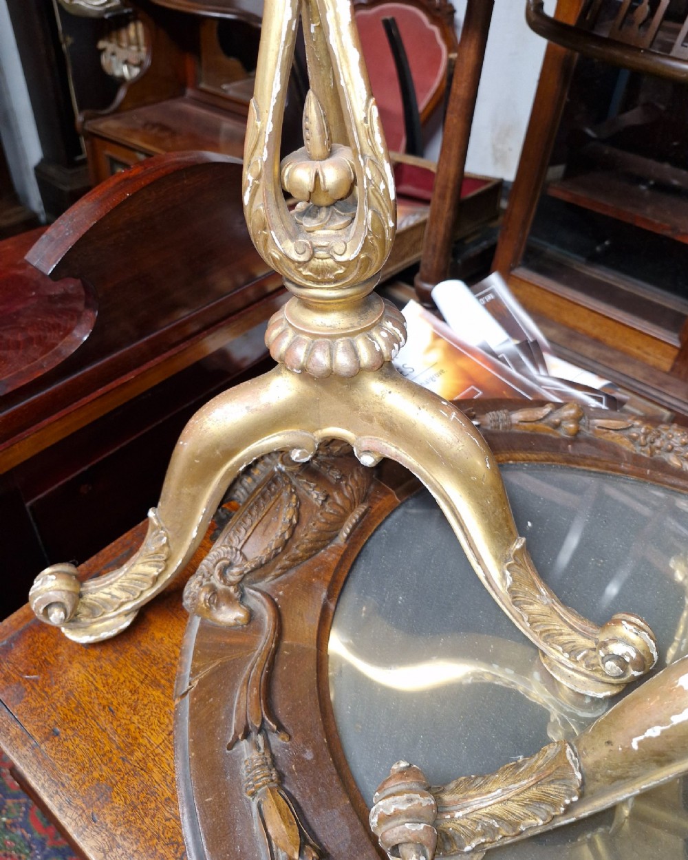A pair of carved wood tripod bases featuring aged gold leaf gilding, scrolled tripod legs, and acanthus leaf carving. View II
