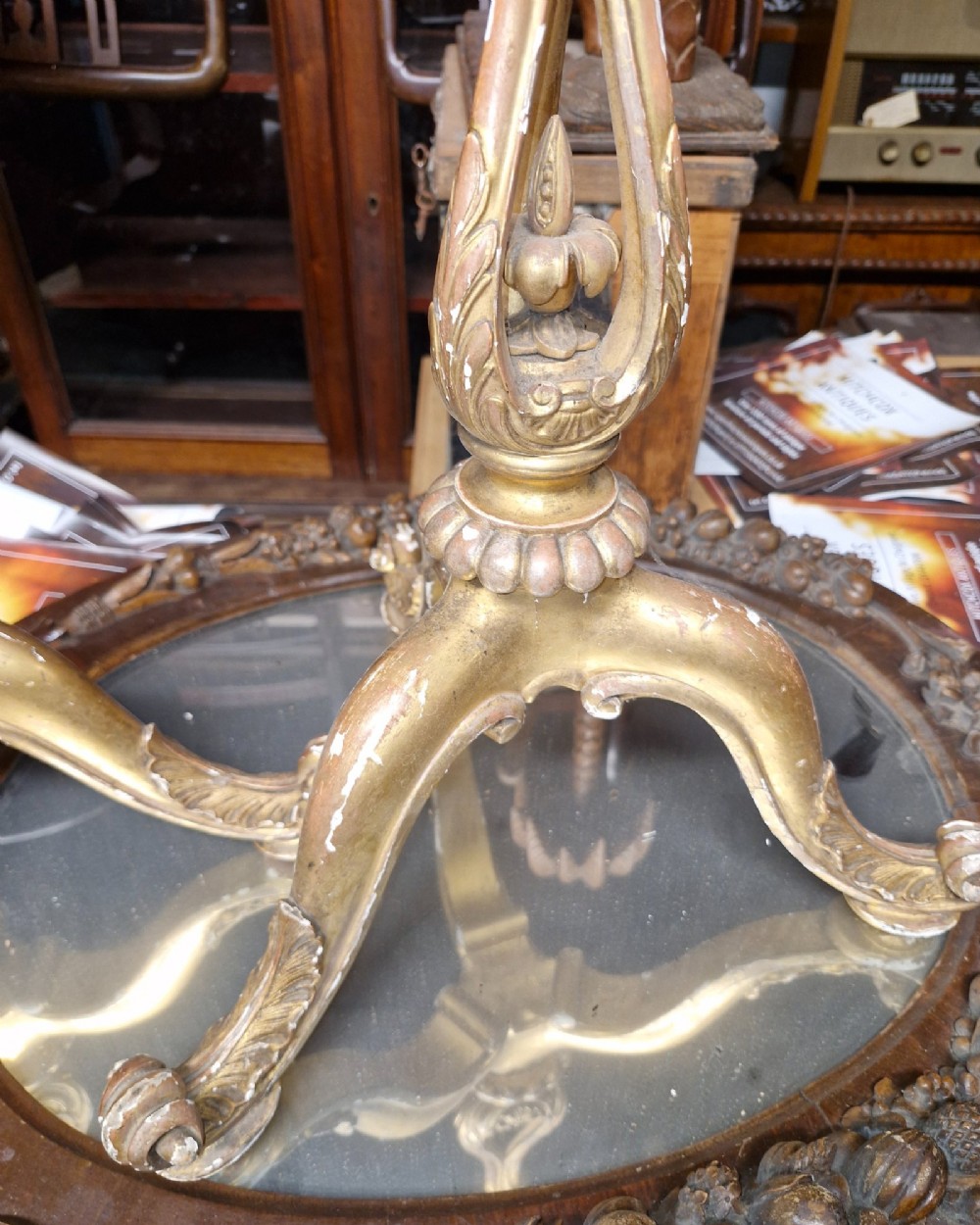 A pair of carved wood tripod bases featuring aged gold leaf gilding, scrolled tripod legs, and acanthus leaf carving. View III