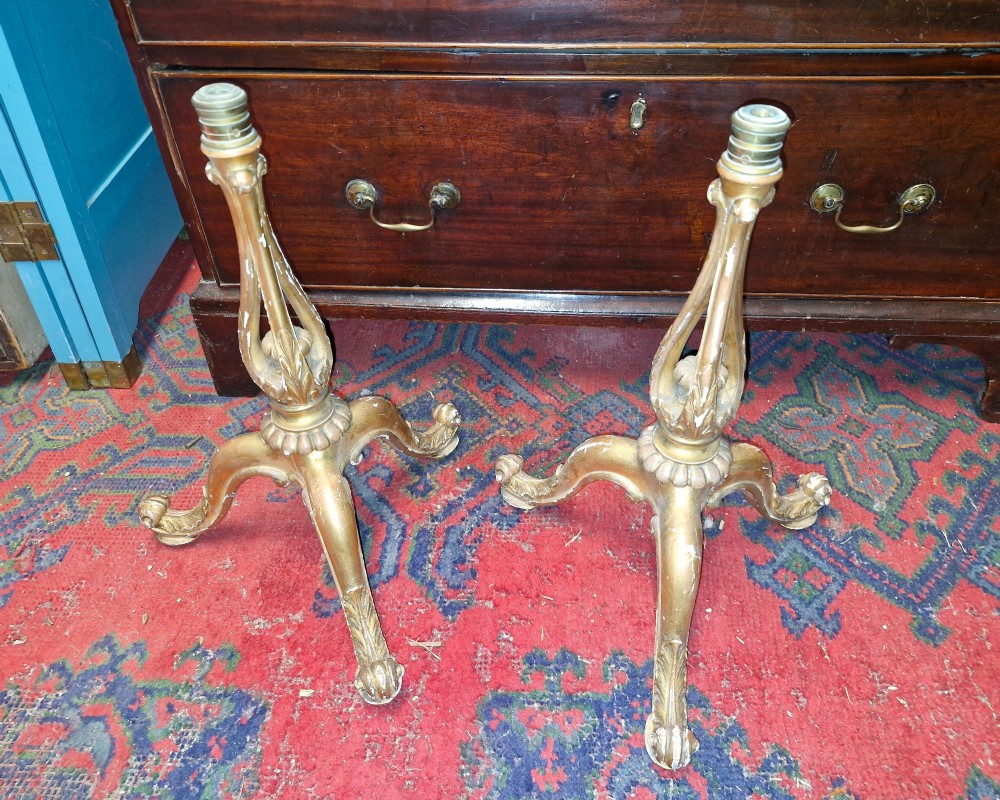 A pair of carved wood tripod bases featuring aged gold leaf gilding, scrolled tripod legs, and acanthus leaf carving. View V