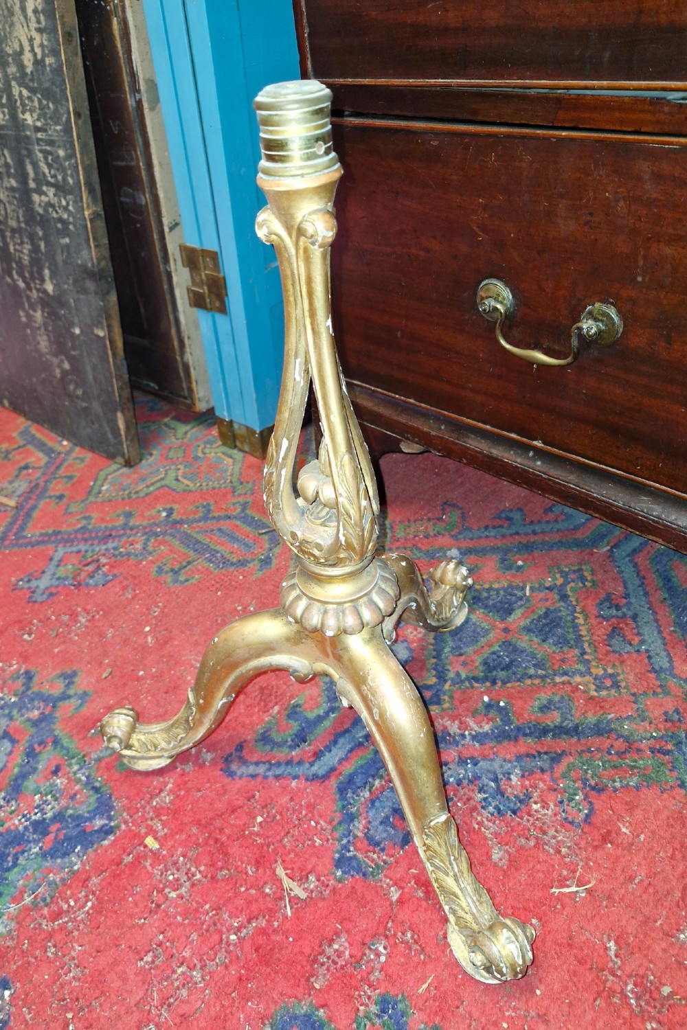 A pair of carved wood tripod bases featuring aged gold leaf gilding, scrolled tripod legs, and acanthus leaf carving. View VII