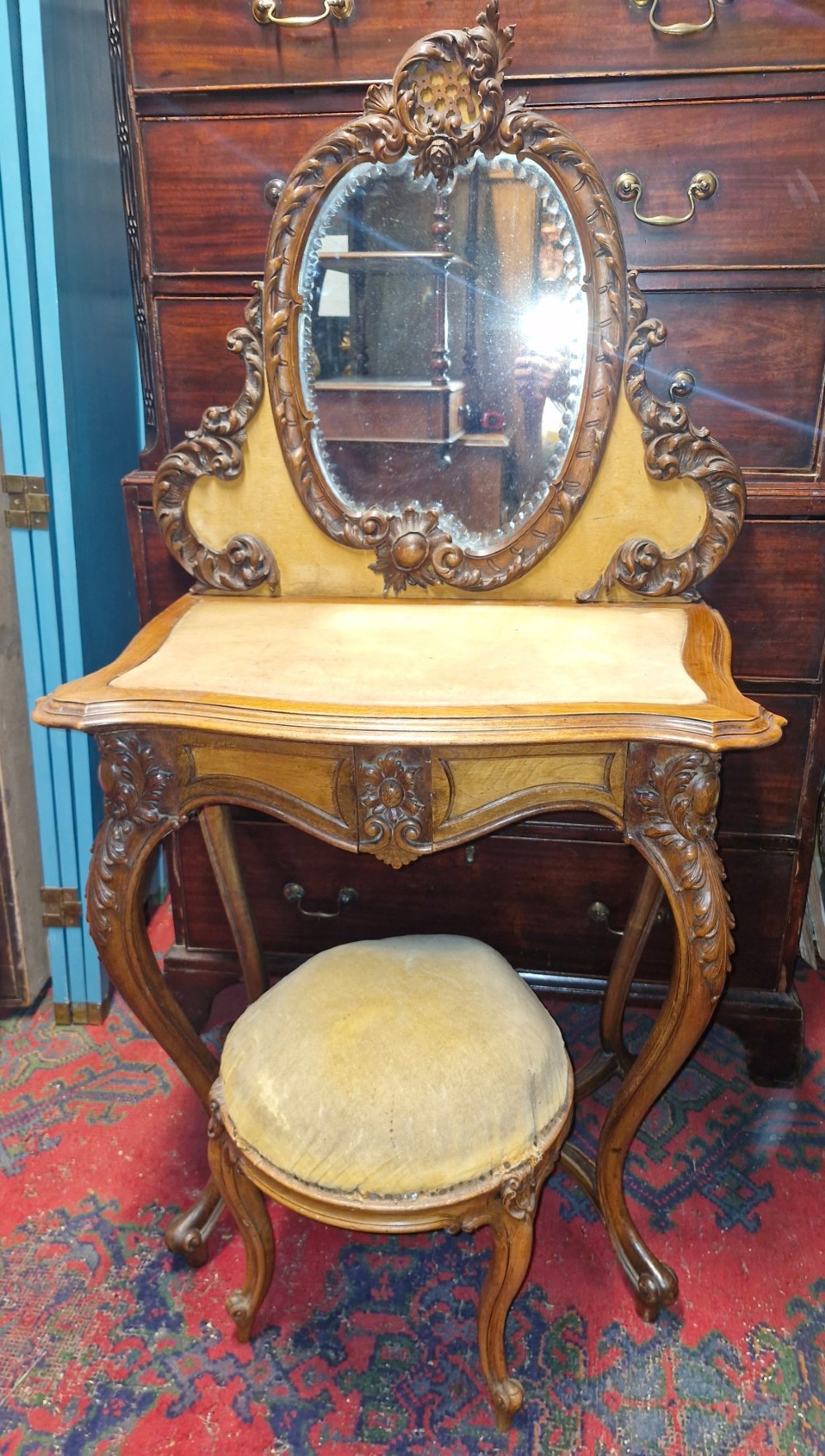 Carved walnut dressing table and stool.