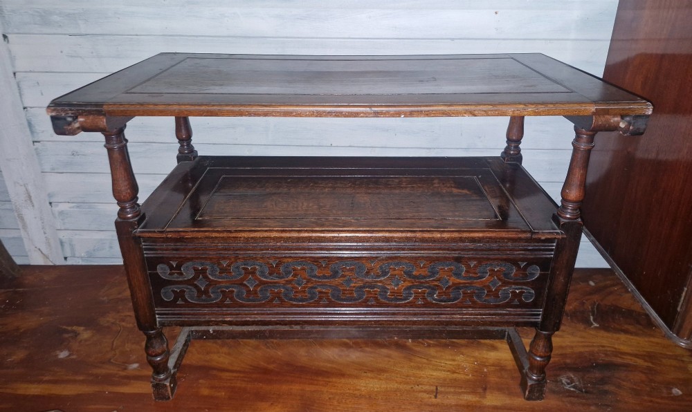 A dark oak monks bench featuring a carved diamond-patterned backrest, turned arm supports, carved front panel, and a lift-up seat. View II