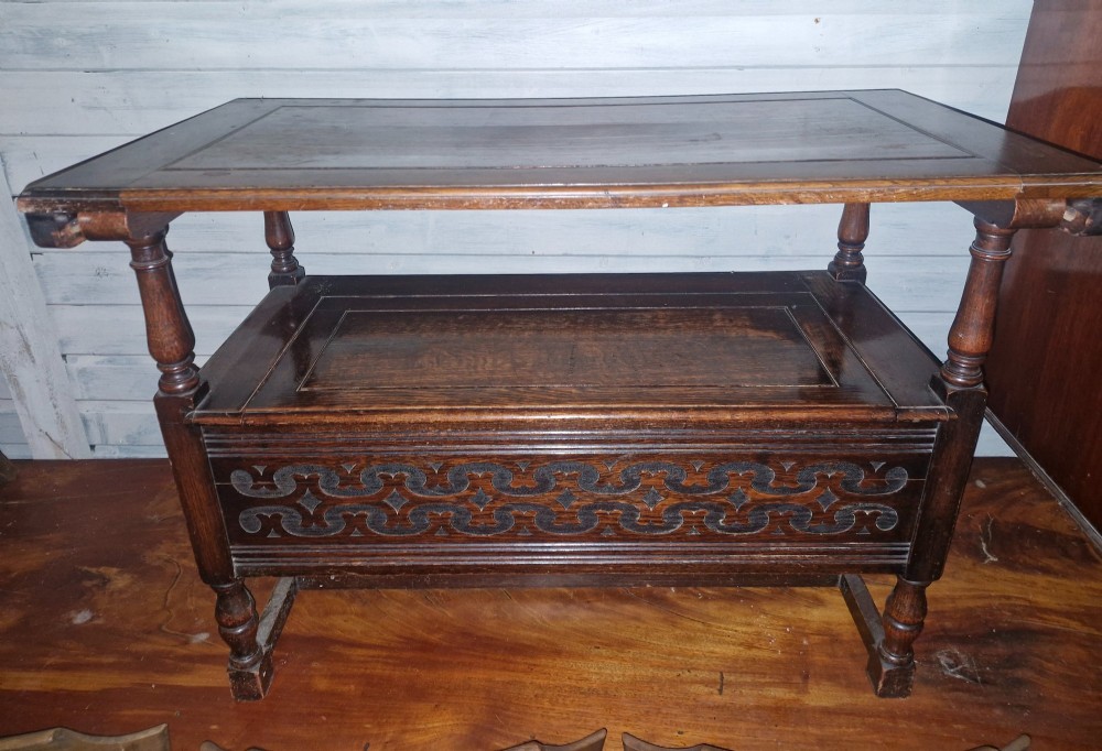 A dark oak monks bench featuring a carved diamond-patterned backrest, turned arm supports, carved front panel, and a lift-up seat. View III