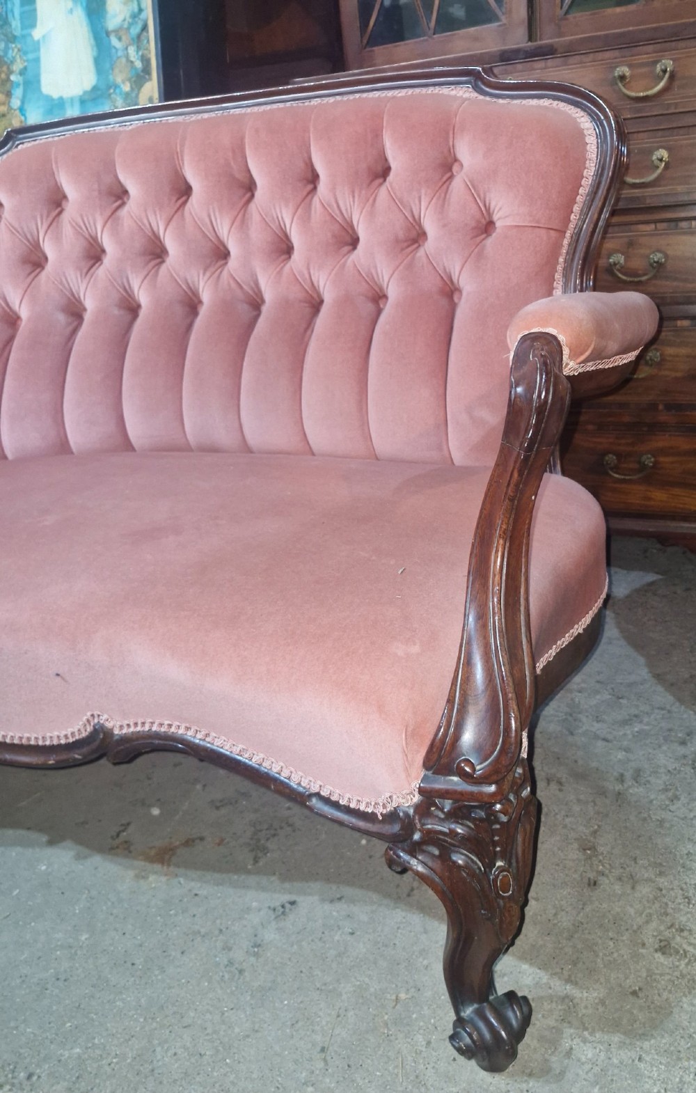 Mid-Victorian carved rosewood settee featuring button-tufted dusky pink velvet upholstery, serpentine backrest, and carved cabriole legs. View VI