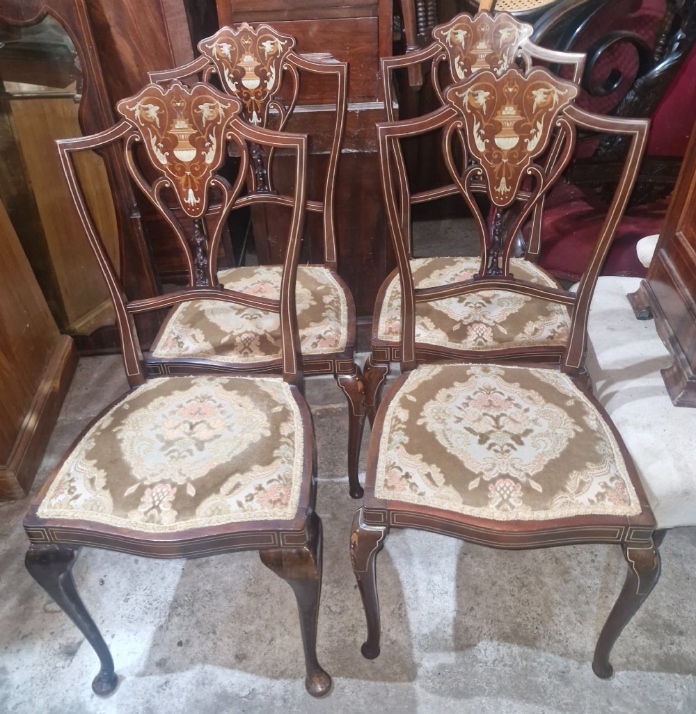 A set of four Edwardian mahogany side chairs featuring inlaid vasiform splats, cabriole front legs, and pattern-upholstered seats. View V