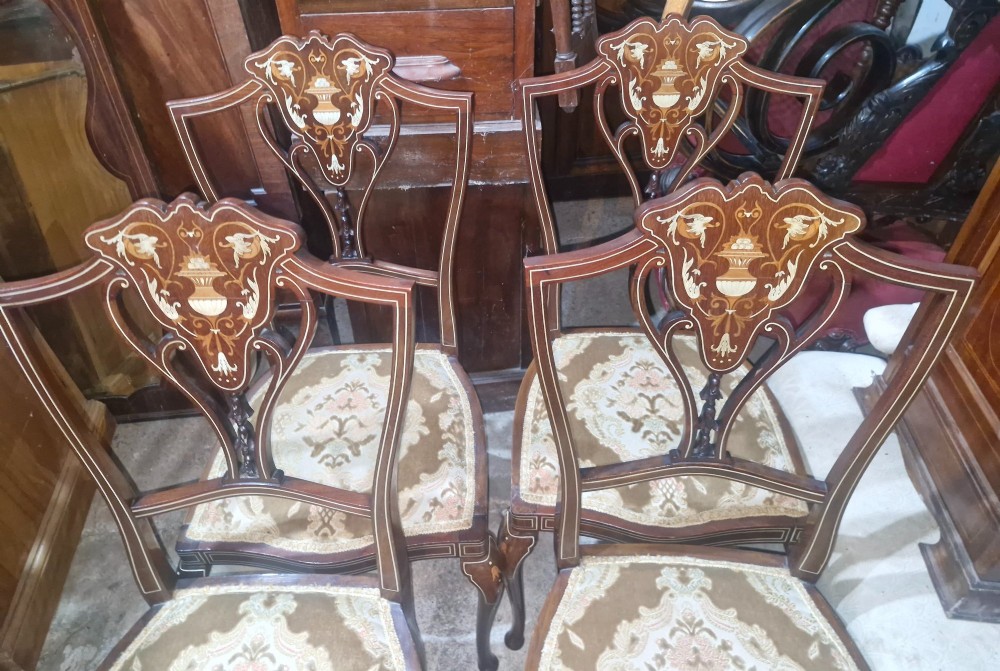 A set of four Edwardian mahogany side chairs featuring inlaid vasiform splats, cabriole front legs, and pattern-upholstered seats. View VI