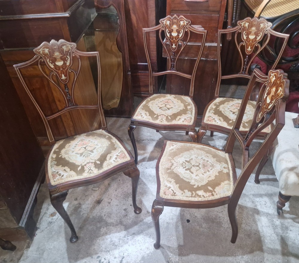 A set of four Edwardian mahogany side chairs featuring inlaid vasiform splats, cabriole front legs, and pattern-upholstered seats. View VIII