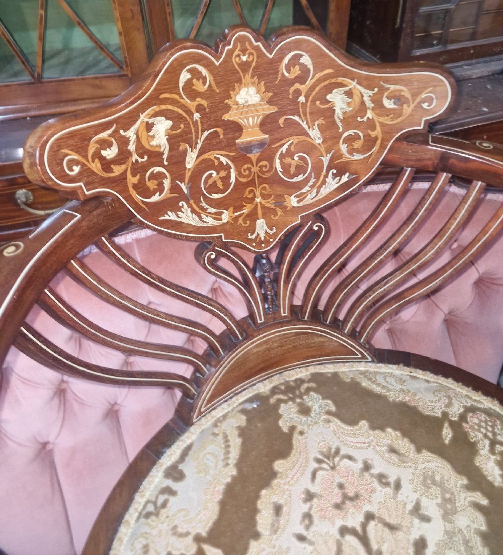 An Edwardian mahogany tub chair featuring floral marquetry inlay on the back splat, sweeping armrests, and an upholstered seat. View II