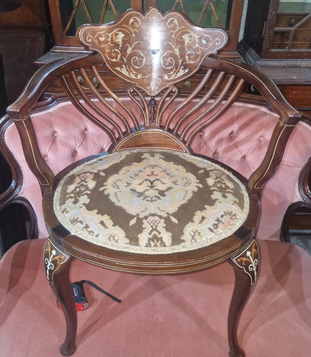 An Edwardian mahogany tub chair featuring floral marquetry inlay on the back splat, sweeping armrests, and an upholstered seat. View III