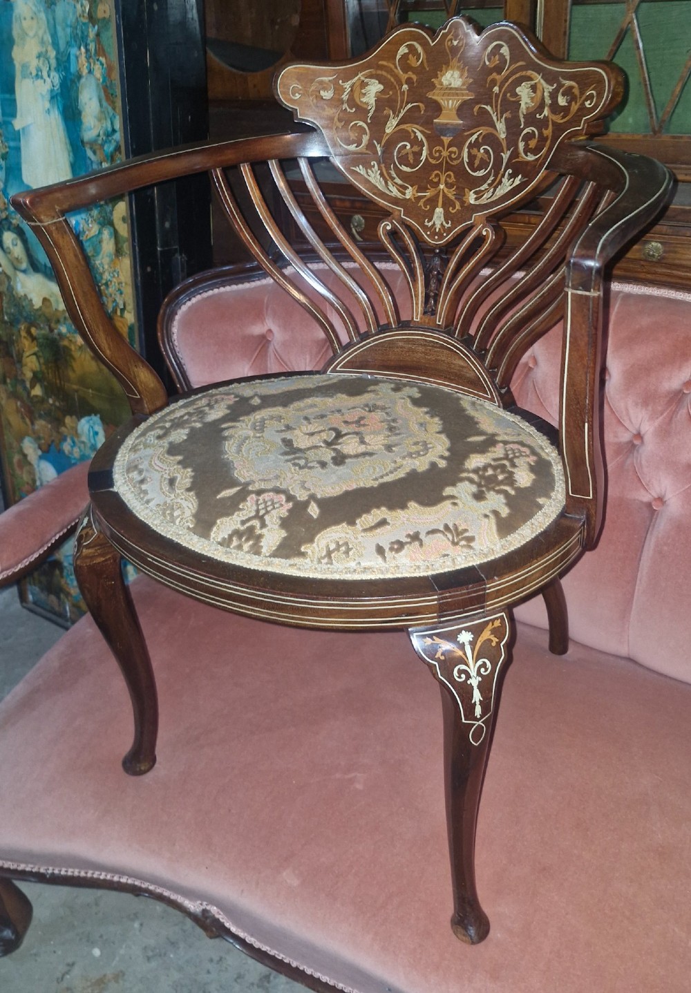 An Edwardian mahogany tub chair featuring floral marquetry inlay on the back splat, sweeping armrests, and an upholstered seat. View IV